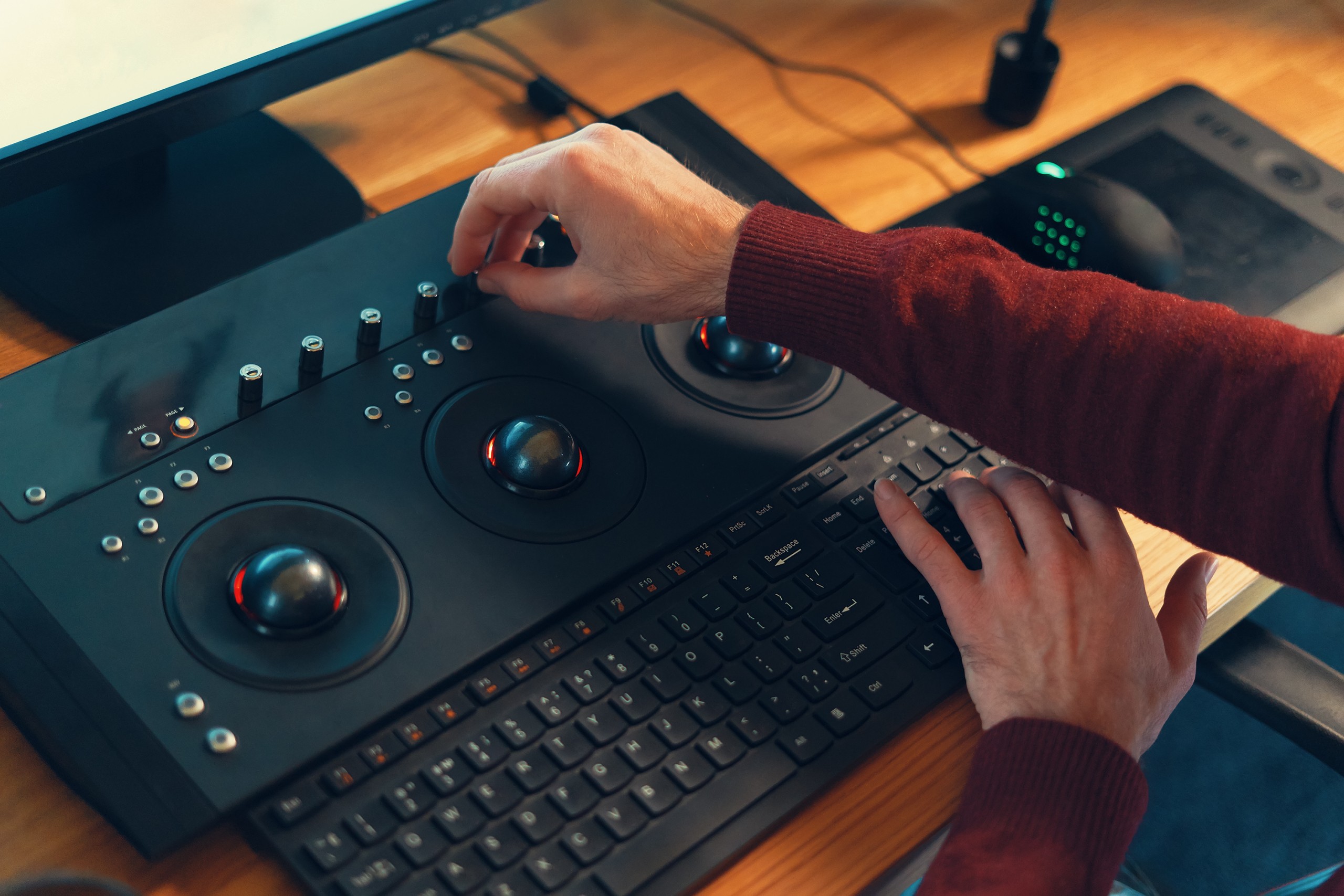 Video editor hands adjusting color or sound on working console machine in the post production stage.